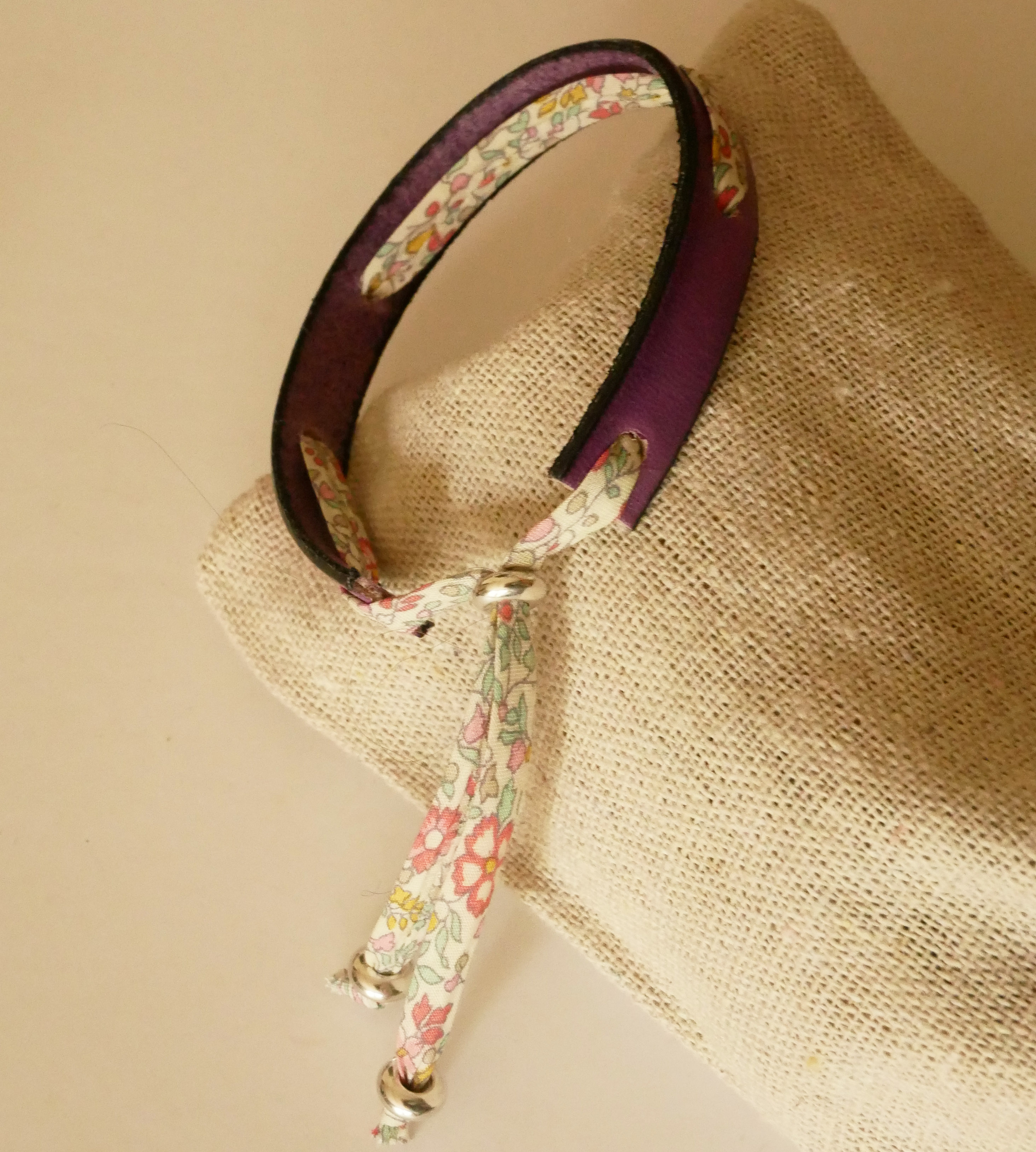 Pulsera Florâme "Brille" grabada con lazo liberty pastel sobre cuero morado